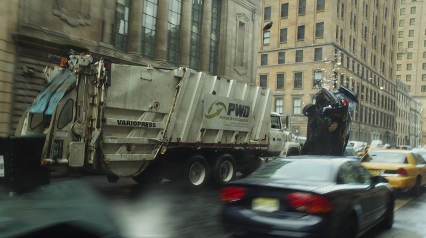 A garbage truck slams through traffic.