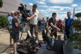 Director James Gunn and his team with a Rocket stuffie.