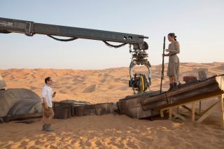 Director J.J. Abrams on set with Daisy Ridley (Rey).