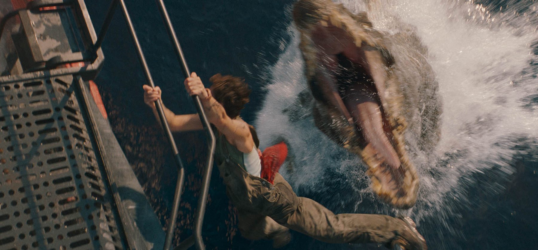 L to R: Philippine Velge and the Spinosaurus in JURASSIC WORLD REBIRTH, directed by Gareth Edwards.